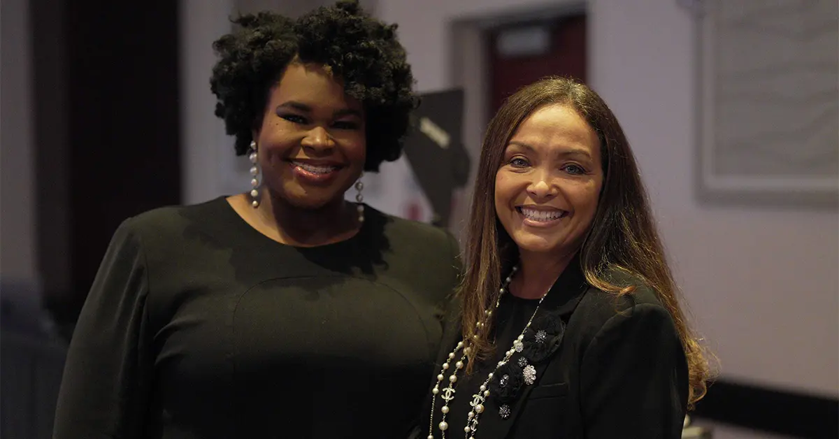 Two Women Standing Next to Each Other